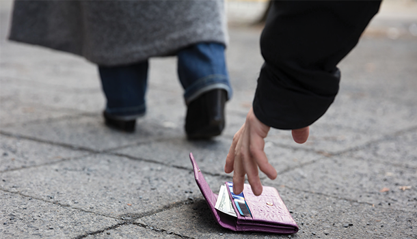 Man picking up dropped wallet