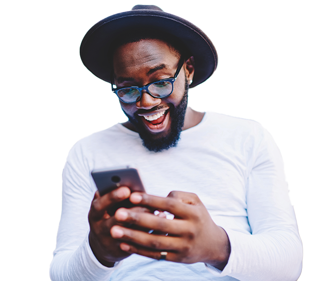 man with hat on looking at his phone