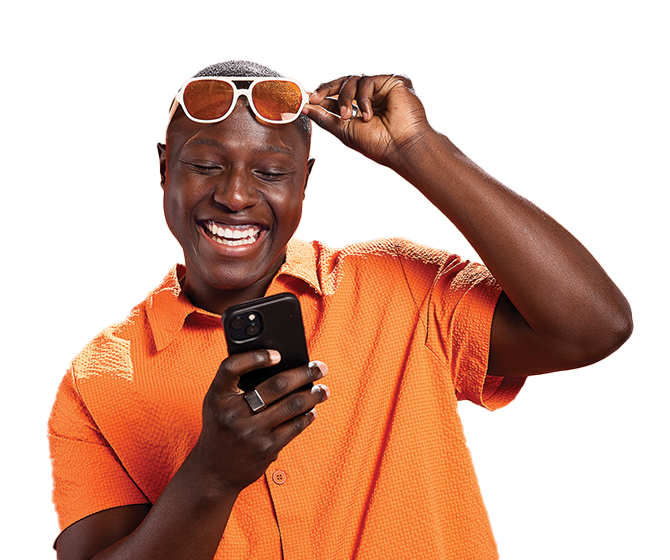 Man putting glasses on his head while reading his phone